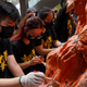 University students clean the "Pillar of Shame" statue at the University of Hong Kong on the 32nd anniversary of the crackdown on pro-democracy demonstrators at Beijing's Tiananmen Square in 1989, in Hong Kong, China June 4, 2021.